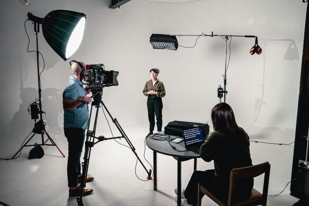 Presenter filmed in a studio with a teleprompter