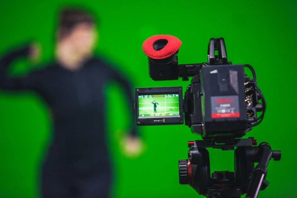 Camera filming in front of a green screen