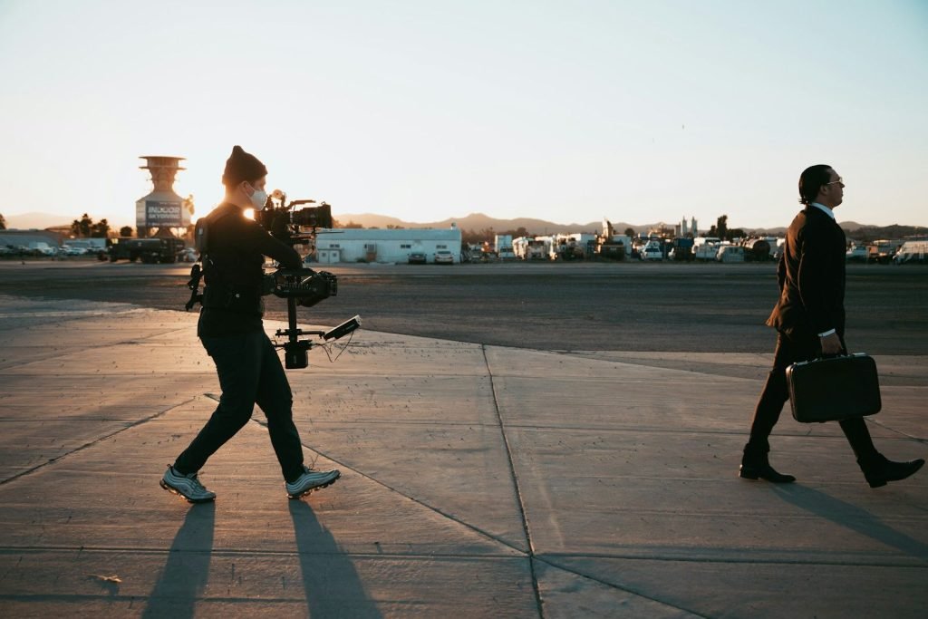 Camera crew walking across an airport apron