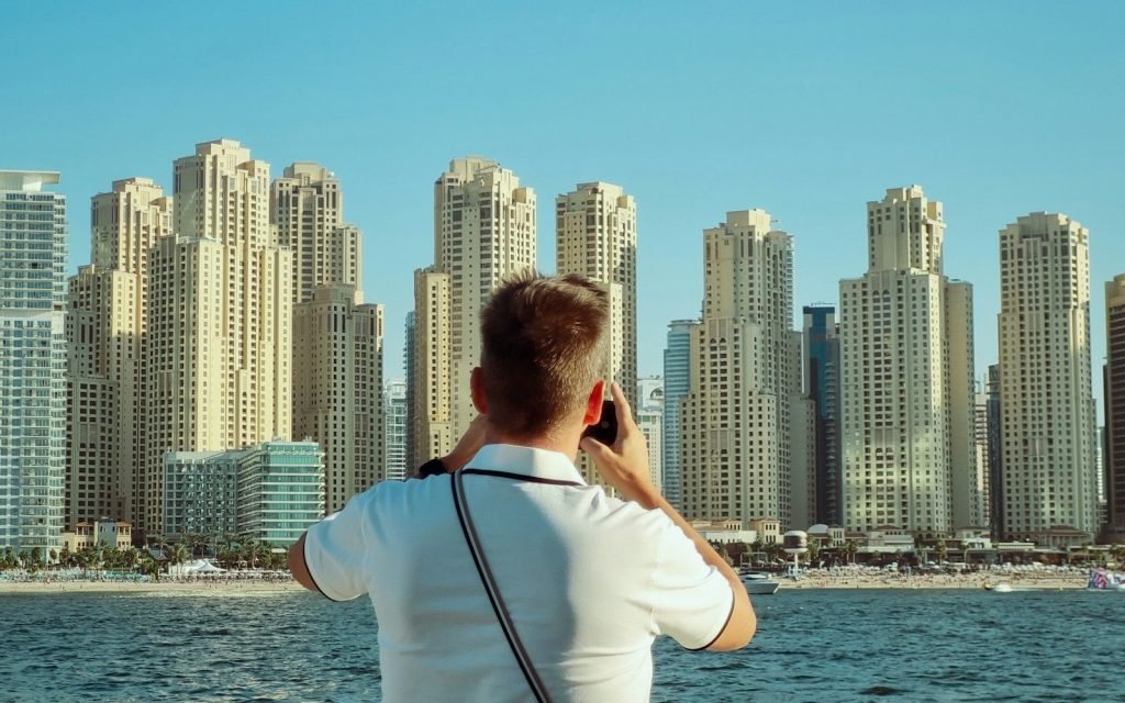 Location scout photographing Dubai Marina towers