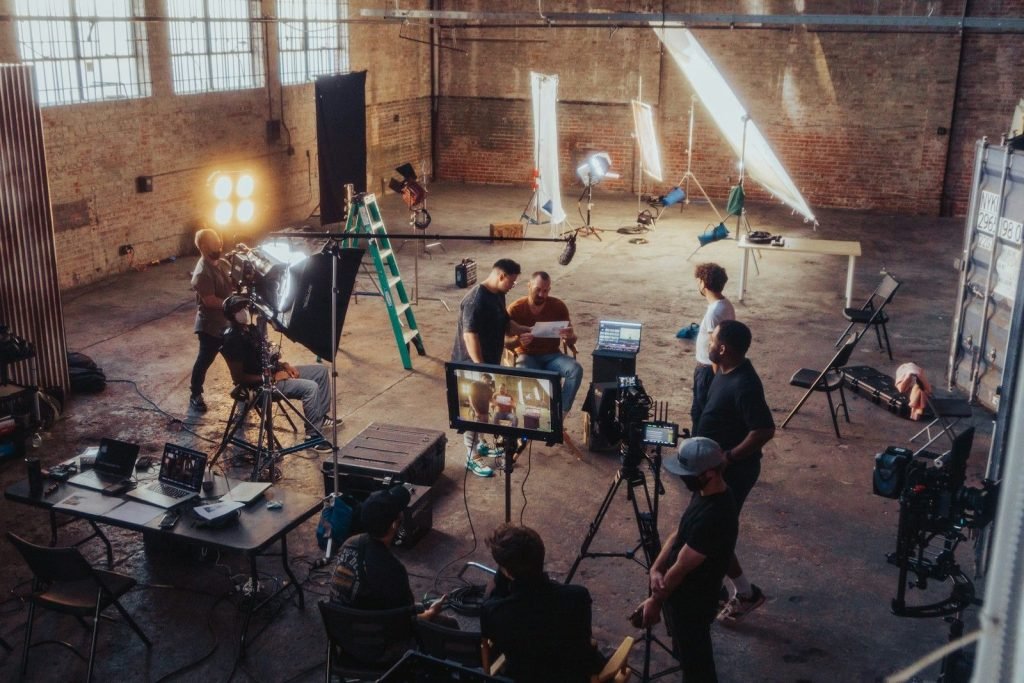 Large film set with lights and crew
